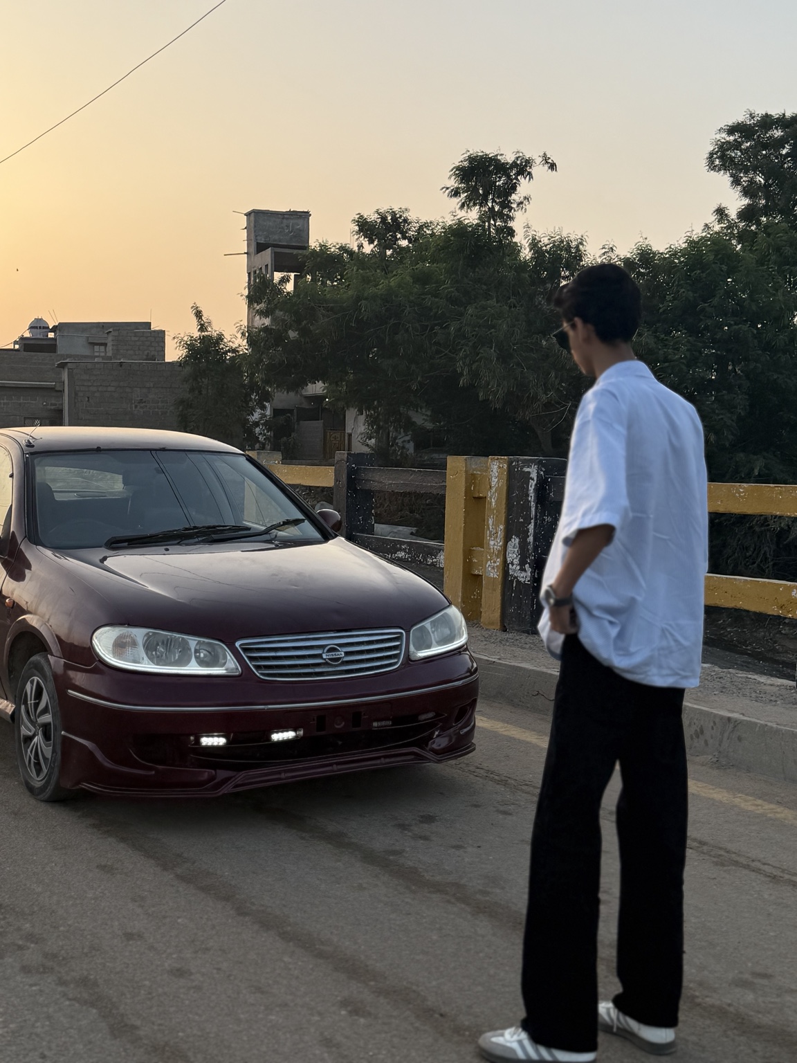 M. Ishmaan with the car he bought through his work